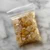 a bag of mini yellow quartz tumbled chips